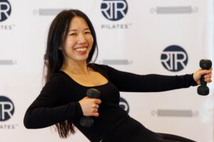 woman smiling during DC pilates class strength training 