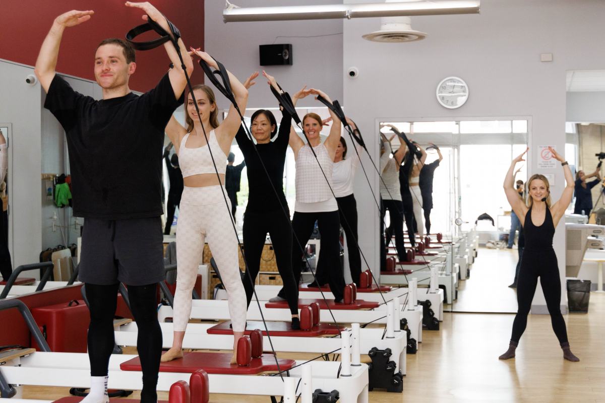 RTR Pilates class doiong standing arms