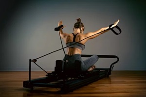 young girl doing pilates exercises with a reformer bed in Washington DC