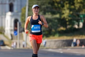 young sporty woman running in marathon competition