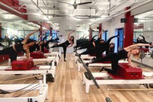 Reformer pilates class in Potomac doing side box kick