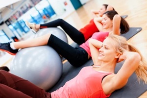 group of people working out in pilates class 