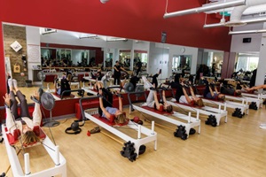 group of young girls doing reformer pilates