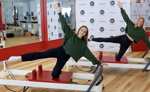 two DC pilates instructors doing reformer pilates
