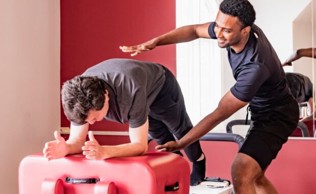 Men on reformer in DC pilates class