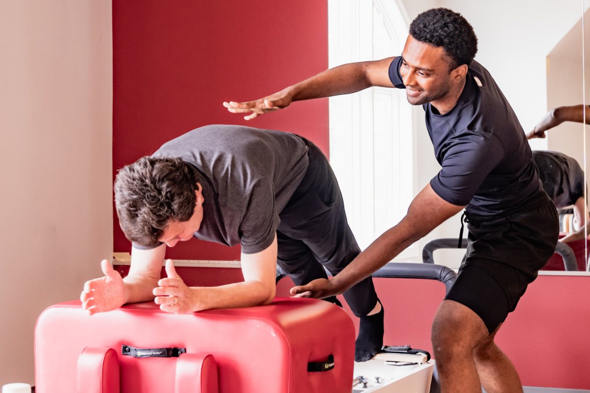 Men on reformer in DC pilates class