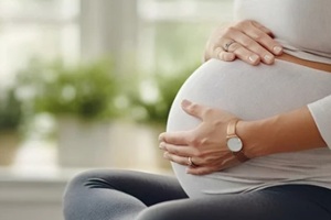 pregnant woman meditating in studio apartment