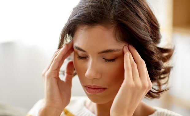 people , health and stress concept - unhappy woman suffering from head ache at home