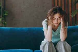 stressed women sitting on sofa